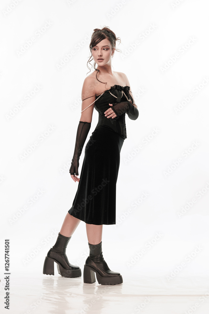 Young beautiful girl brunette of an eastern outbreak of black dress on a white background Young beautiful girl brunette of an eastern outbreak of black dress on a white background