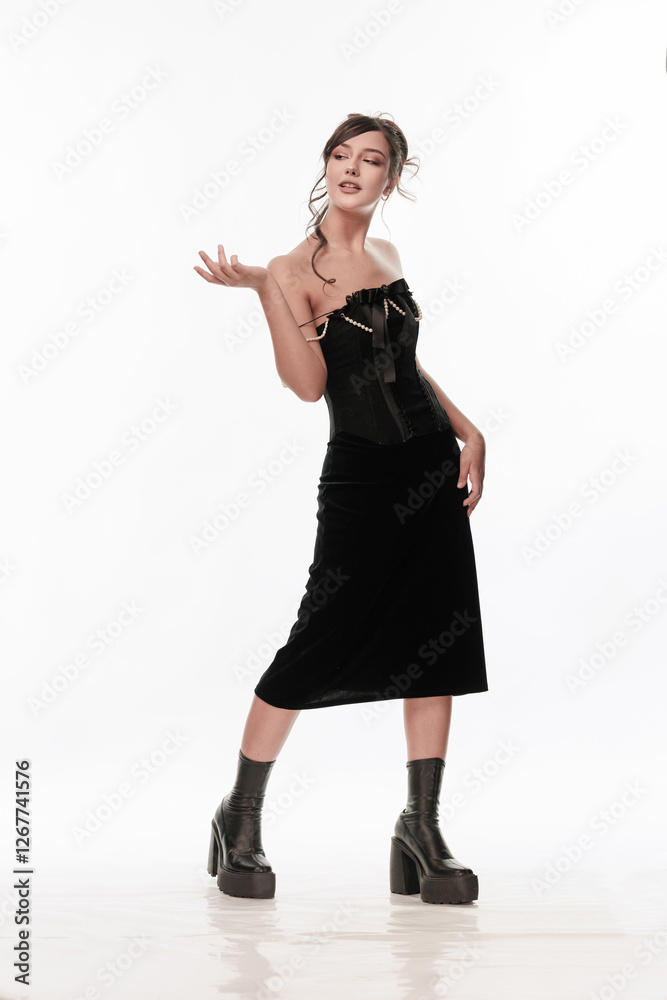 Young beautiful girl brunette of an eastern outbreak of black dress on a white background Young beautiful girl brunette of an eastern outbreak of black dress on a white background