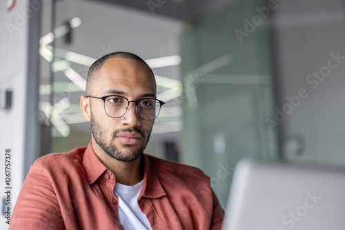 Wallpaper Mural Serious thinking businessman close up working with laptop inside office, businessman looking at screen with concentration and focus, preparing electronic presentation and report. Torontodigital.ca