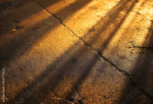 Golden Light and Shadows on Concrete Floor - Abstract Texture Background