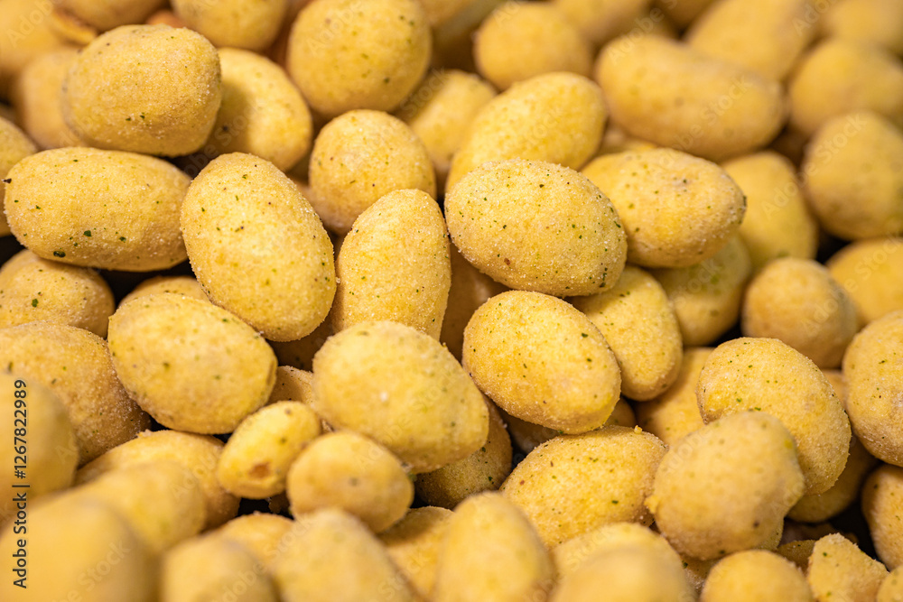 A macro shot of crunchy, spice-coated peanuts with a golden yellow hue. The textured surface highlights their crunchy coating, making them a tasty snack option. A macro shot of crunchy, spice-coated peanuts with a golden yellow hue. The textured surface highlights their crunchy coating, making them a tasty snack option.