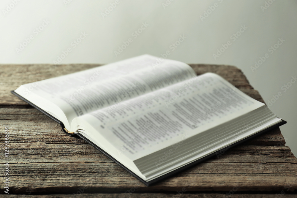 Fototapeta premium Open Holy Bible in English language on wooden table