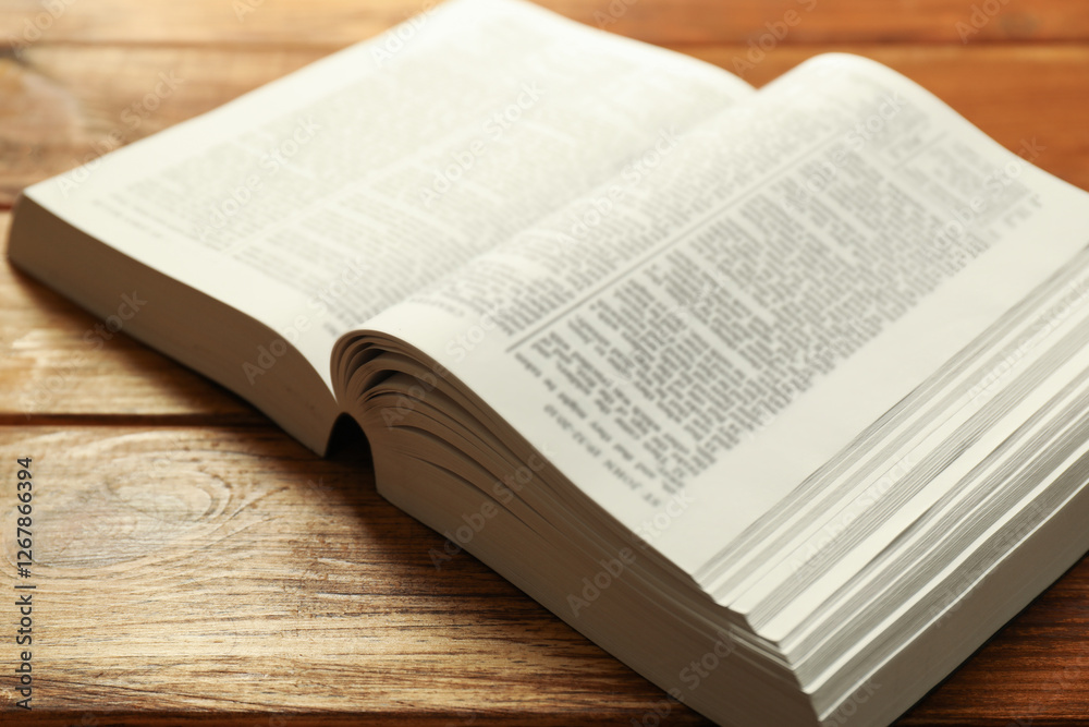 Open Holy Bible in English language on wooden table, closeup Open Holy Bible in English language on wooden table, closeup