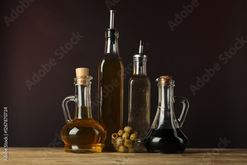 Wallpaper Mural Salad dressings and olives on wooden table against dark background Torontodigital.ca