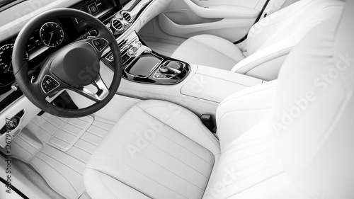 A white car with a steering wheel and a dashboard