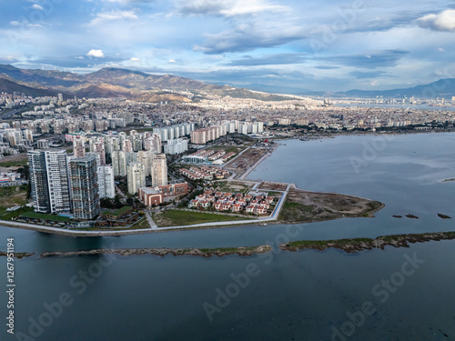 Aerial view of Izmir city, Turkey, featuring skyscrapers, mountains, and coastline photo