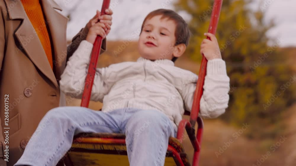 Mother swings son on swing in park. Mother swings son on cute swing in park echoing with laughter. Mother swings son in park sharing moments on swing with laughter filling air making experience Mother swings son on swing in park. Mother swings son on cute swing in park echoing with laughter. Mother swings son in park sharing moments on swing with laughter filling air making experience
