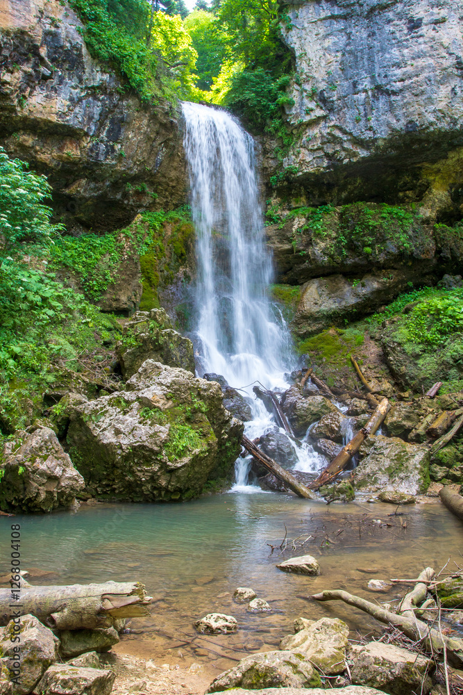 a waterfall, a fragment of a mountain river in the embrace of a stone canyon and a deep riverbed, a spring day in nature a waterfall, a fragment of a mountain river in the embrace of a stone canyon and a deep riverbed, a spring day in nature