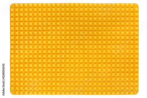 Close-up shot of a yellow silicone mold for cookies. Empty silicone baking mat is isolated on a white background. Front view.