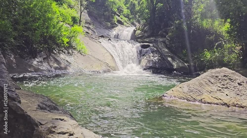 Waterfall in the Sri Lankan forest flowing through the rocks, Bambarakiri Ella falls photo