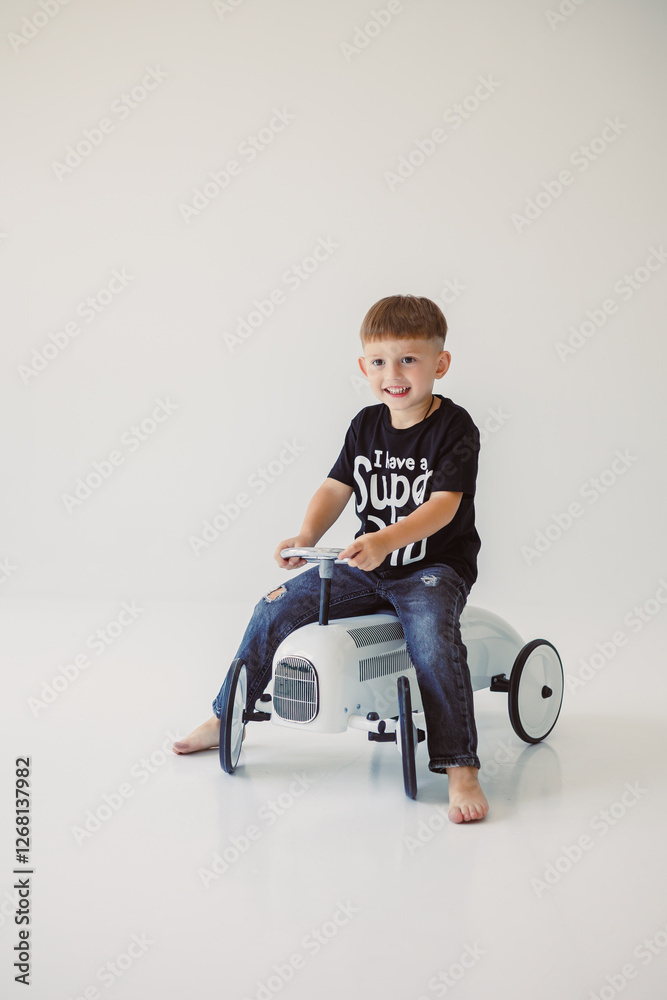 A Playful Child Enjoys Riding a Colorful Toy Tractor Inside a Bright and Fun Studio Space A Playful Child Enjoys Riding a Colorful Toy Tractor Inside a Bright and Fun Studio Space