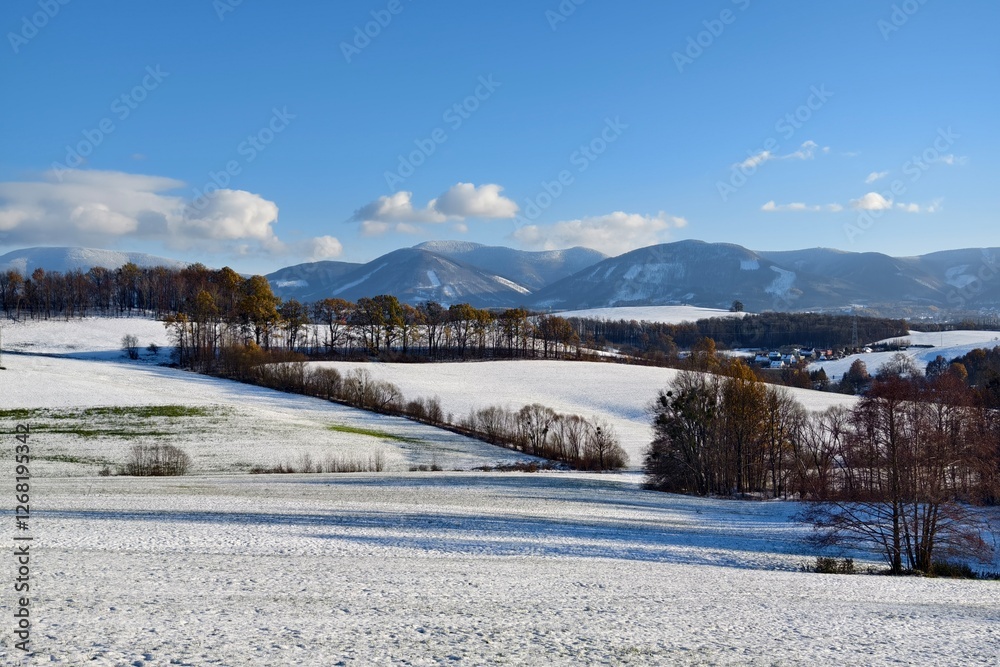 landscape with snowy fields and mountains in the background landscape with snowy fields and mountains in the background