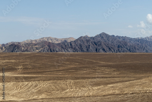 The view of the Andes Mountains from desert-like areas of south Peru
