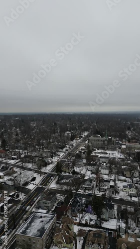 Aerial drone footage of South Jersey in winter, featuring snow-covered rooftops, streets, and urban areas. Capturing the cold season’s atmosphere, this dynamic clip is perfect for real estate, travel,
