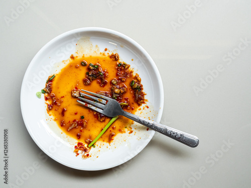 Dirty plate top view background, finished eat dinner in restautant, abstract textuer stain smearing drip sauce bbq jam chilli jelly on ceramic breakfast, concept for clean hyginene product.
