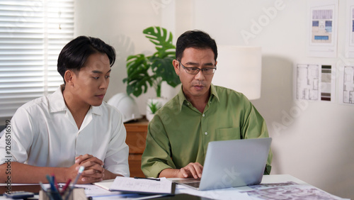 A professional engineering team working on cost estimation and resource allocation for a building project