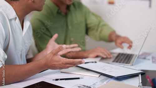 A professional engineering team working on cost estimation and resource allocation for a building project