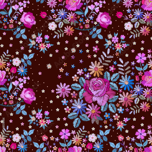 Embroidery floral ornament. Beautiful seamless pattern with bouquets of garden flowers in embroidered style. Print for fabric.