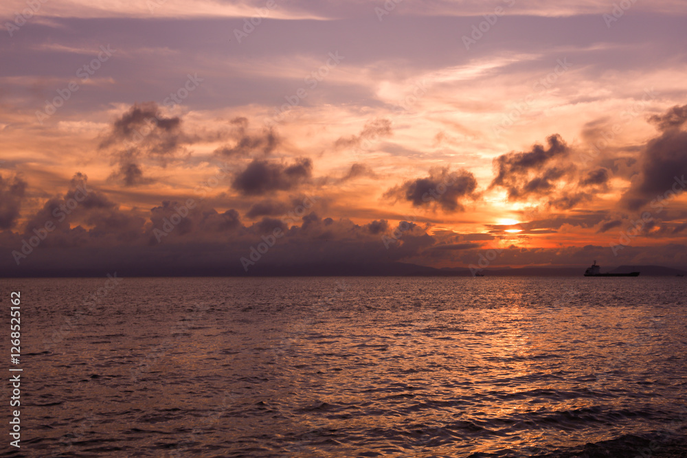Pink sunset sky with many beautiful clouds over sea Pink sunset sky with many beautiful clouds over sea