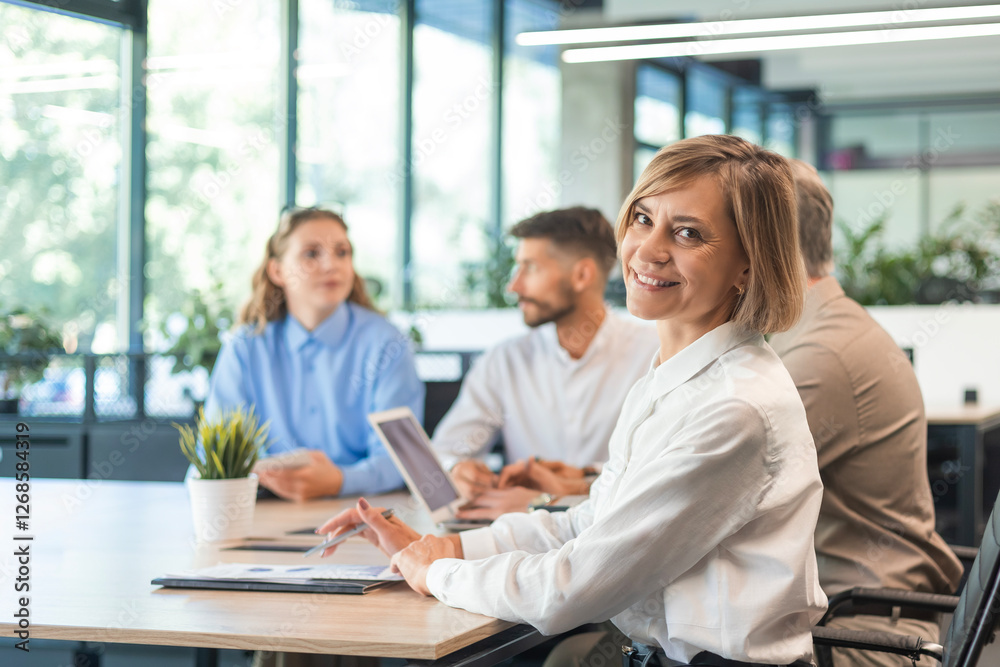 Business woman with her staff, people group in background at modern bright office indoors. Business woman with her staff, people group in background at modern bright office indoors.