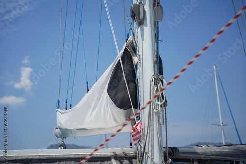 A white voyage boat featuring a steering wheel floating in the water