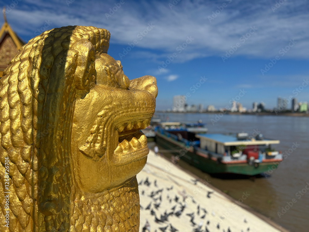 Golden statue next to the Mekong river