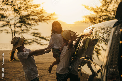 Bilde på lerret Asian family playing near car window at sunset feeling funny in holidays and relaxation together