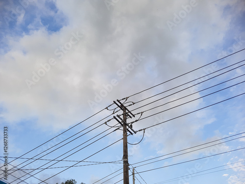 Electric poles and cables against the sky