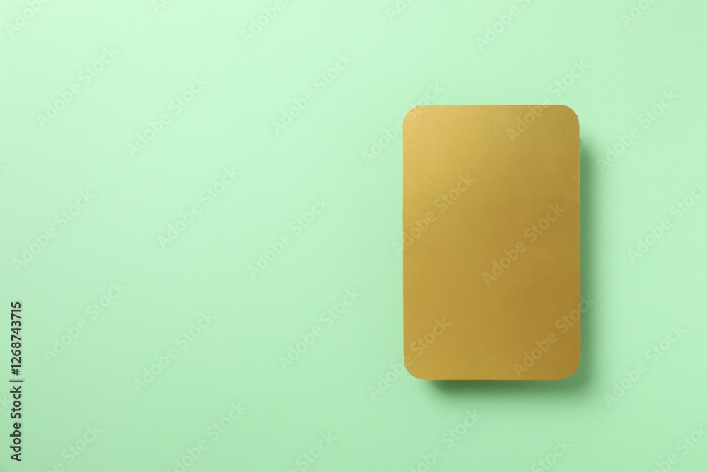 Golden paper card on color background Golden paper card on color background