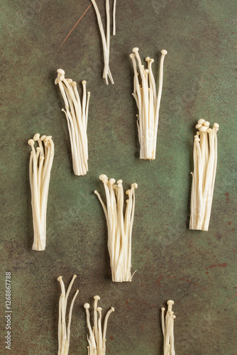 Popular in asian cuisine fresh golden needle mushroom or enoki, enokitake (Flammulina velutipes). Top view photo