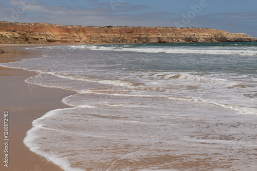 Wave patterns on the shoreline of Maslins nudist beach photo