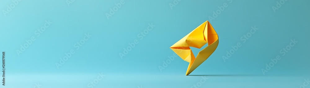 Fototapeta premium A vibrant yellow origami paper shape floats against a calming blue background, symbolizing creativity and innovation in design. Perfect for art and design-related projects.