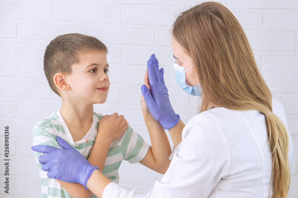 Boy at doctor's appointment taking temperature. Pediatrician's appointment, healthcare concept Boy at doctor's appointment taking temperature. Pediatrician's appointment, healthcare concept