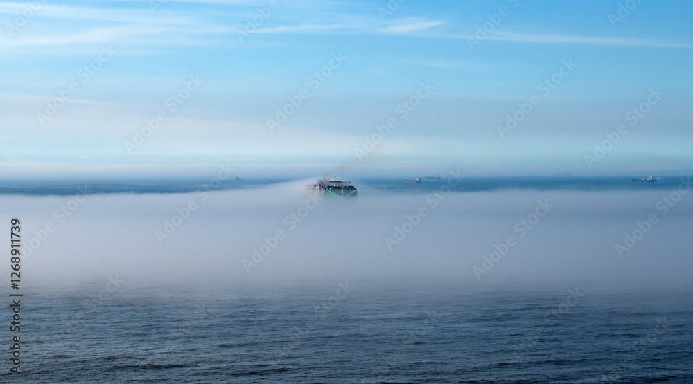 Container ship passing through the fog in the bay of Rio de Janeiro Container ship passing through the fog in the bay of Rio de Janeiro