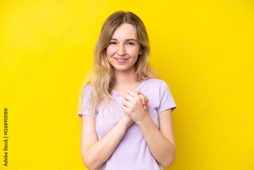 Obraz premium Blonde English young girl isolated on yellow background laughing