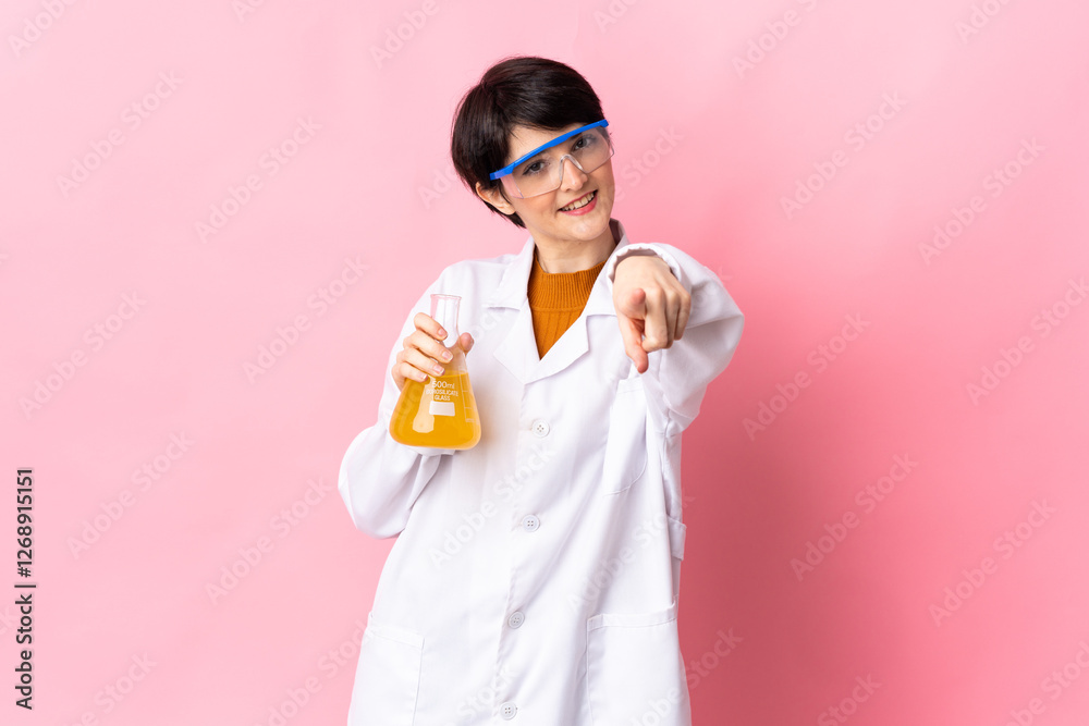 Young scientific woman isolated on pink background pointing front with happy expression Young scientific woman isolated on pink background pointing front with happy expression