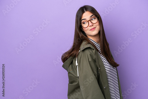 Young Brazilian woman isolated on purple background . Portrait