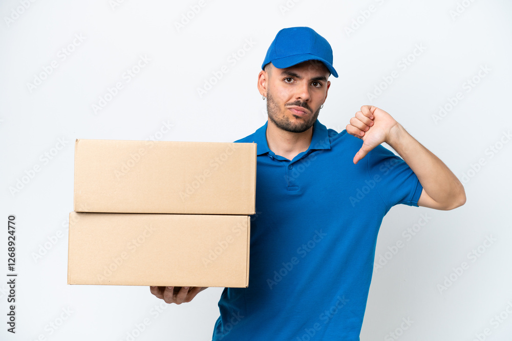 Delivery caucasian man isolated on white background showing thumb down with negative expression Delivery caucasian man isolated on white background showing thumb down with negative expression