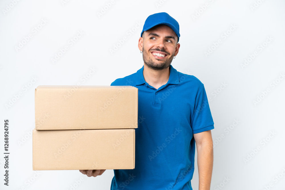 Delivery caucasian man isolated on white background thinking an idea while looking up Delivery caucasian man isolated on white background thinking an idea while looking up