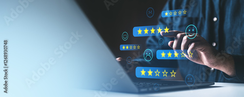 Person interacting with digital customer feedback and star rating icons on a laptop screen. Concept of online reviews and service satisfaction.