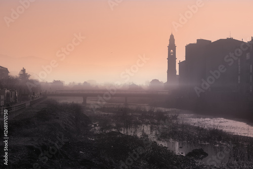 winter landscape with fog in the soft morning light with fog rising up from a river