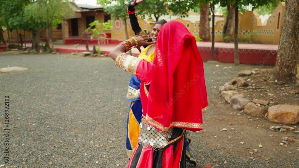 Ladies into ethnic dress dance at rural landscape Ladies into ethnic dress dance at rural landscape