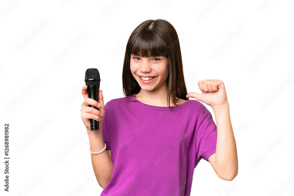 Little singer girl picking up a microphone over isolated background proud and self-satisfied Little singer girl picking up a microphone over isolated background proud and self-satisfied