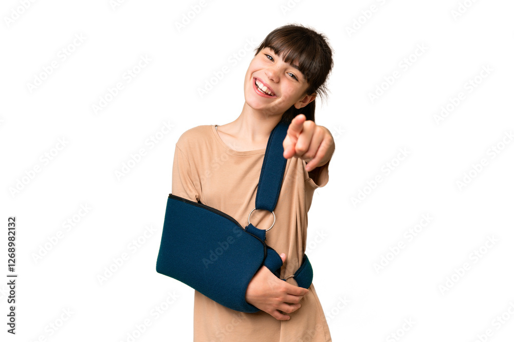 Little caucasian girl with broken arm and wearing a sling over isolated background pointing front with happy expression Little caucasian girl with broken arm and wearing a sling over isolated background pointing front with happy expression