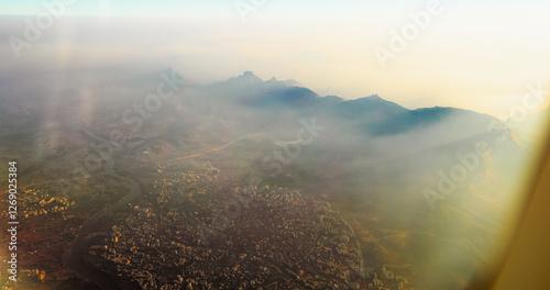 Ulhas river, Mumbai, India. Badlapur is a city in Thane district, Maharashtra state, India, and is a part of Mumbai Metropolitan Region. Aerial View From Airplane Window On View of the Mumbai suburb photo