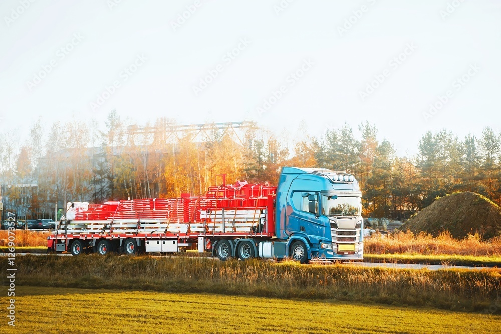 Fototapeta premium Blue truck delivering construction equipment