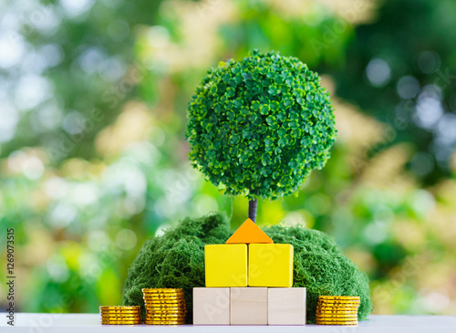 Real estate investment concept with golden coins, eco-friendly house model, and green tree, symbolizing financial growth, property market, wealth building, and sustainable housing. photo