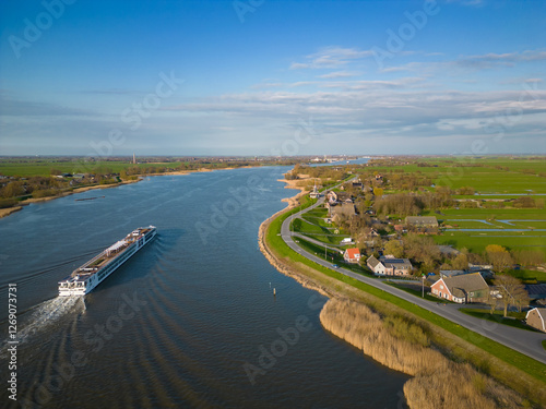 Small cruise ship sailing on a Dutch river seen from above