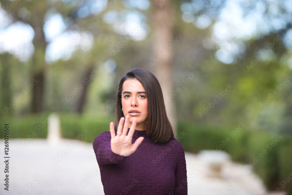 Woman making STOP gesture with hands, stop violence against women, human rights violations, human trafficking. Focus on the face. Advertising campaign. Woman making STOP gesture with hands, stop violence against women, human rights violations, human trafficking. Focus on the face. Advertising campaign.