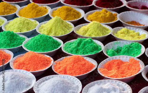 A vibrant assortment of food colors in small bottles for culinary use.